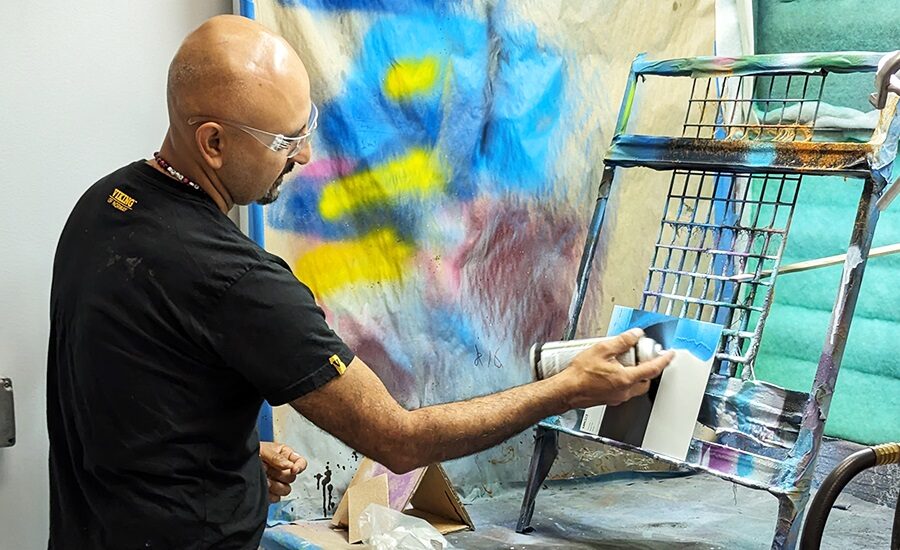 Graffiti artist GONZO247 painting on a canvas in an art studio