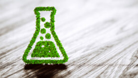 Green chemistry industry sign on black wooden background