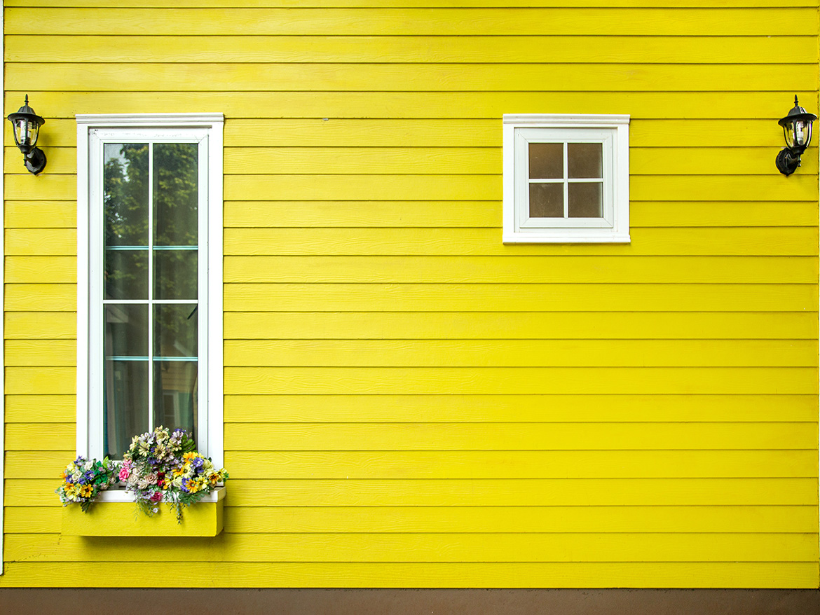 yellow painted siding on side of house