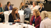 Photo of women sitting at a table at the Women in Finishing FORUM